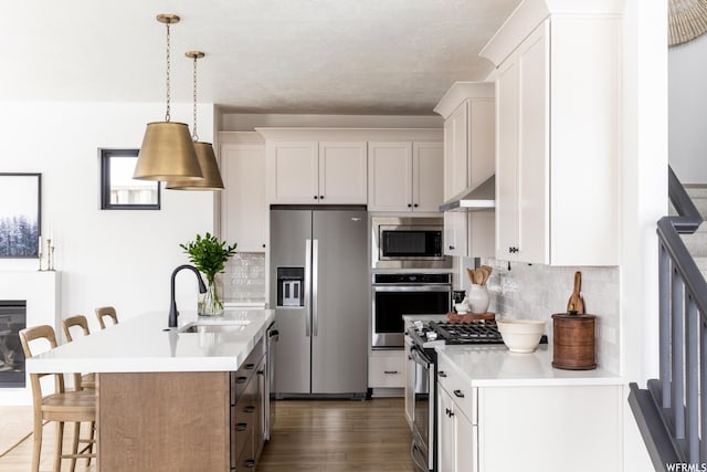 6962 Elk Wallow Dr Unit 7, Park City, UT 84098 - kitchen with light countertops, appliances with stainless steel finishes, a kitchen bar, and a sink