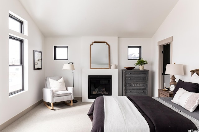 6962 Elk Wallow Dr Unit 7, Park City, UT 84098 - bedroom featuring baseboards, carpet floors, lofted ceiling, and a glass covered fireplace