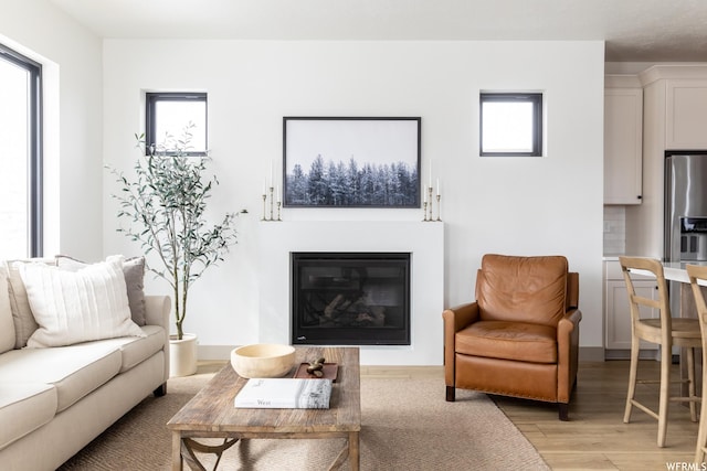 6962 Elk Wallow Dr Unit 7, Park City, UT 84098 - living area featuring light wood finished floors and a glass covered fireplace