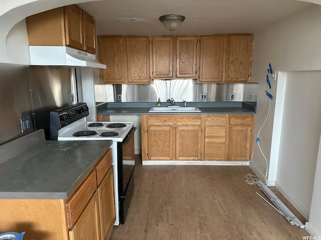 196 S Center St, American Fork, UT 84003 - kitchen with under cabinet range hood, a sink, black range with electric cooktop, wood finished floors, and dark countertops