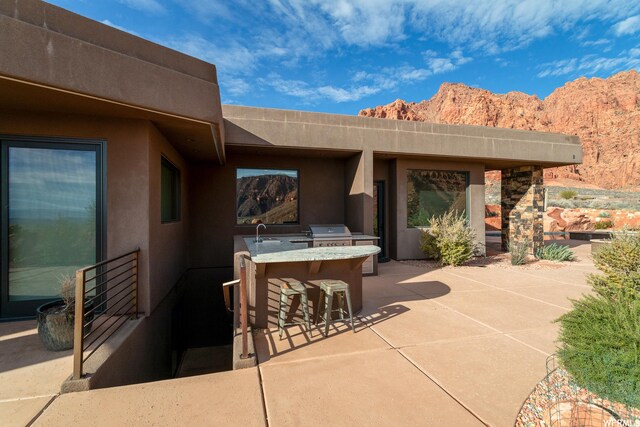 854 W Tawgoo Ct, Ivins, UT 84738 - view of patio / terrace featuring exterior kitchen, a grill, a sink, and a mountain view
