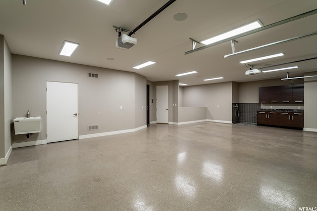 854 W Tawgoo Ct, Ivins, UT 84738 - garage with a garage door opener, visible vents, and baseboards