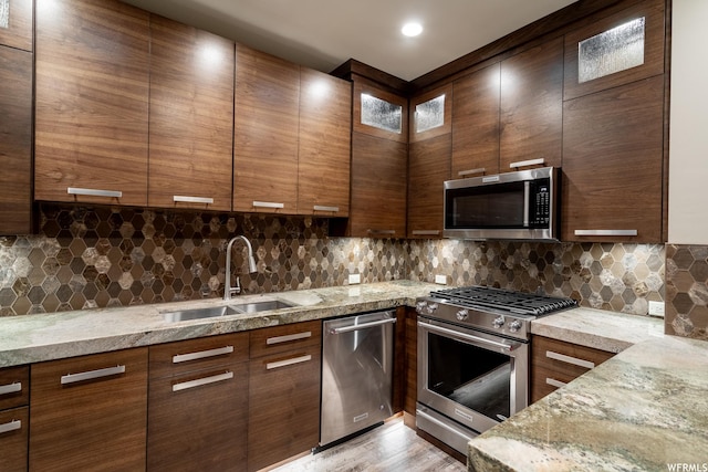 854 W Tawgoo Ct, Ivins, UT 84738 - kitchen featuring light stone countertops, decorative backsplash, stainless steel appliances, and a sink