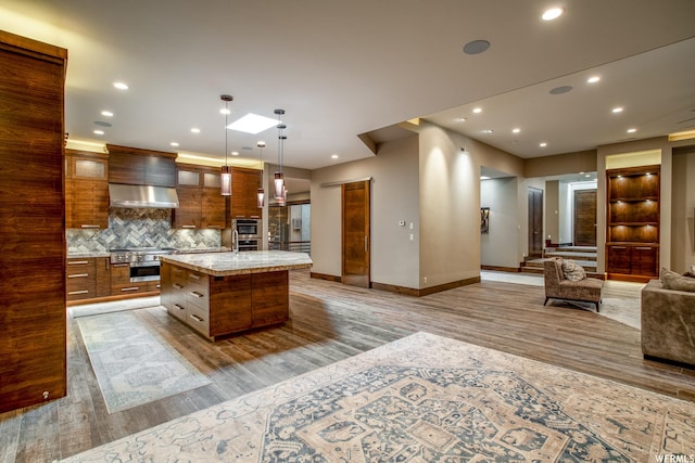 854 W Tawgoo Ct, Ivins, UT 84738 - kitchen with wood finished floors, open floor plan, light countertops, a large island, and tasteful backsplash