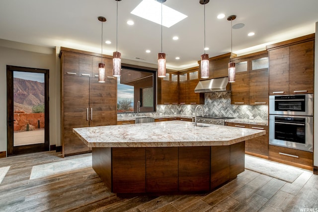 854 W Tawgoo Ct, Ivins, UT 84738 - kitchen featuring double oven, light countertops, decorative backsplash, and extractor fan