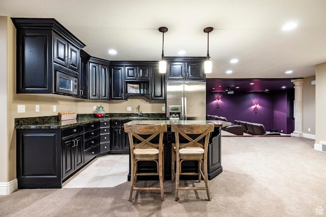 3626 E Granite Bench Ln S, Sandy, UT 84092 - kitchen featuring decorative light fixtures, appliances with stainless steel finishes, light carpet, dark stone counters, and ornate columns