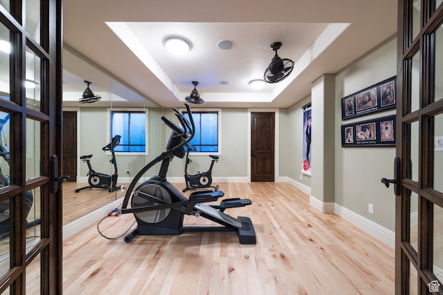 3626 E Granite Bench Ln S, Sandy, UT 84092 - workout area with light hardwood / wood-style flooring, a tray ceiling, and french doors
