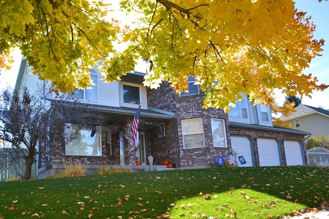 view of front of property with a front yard and a garage