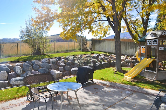 1605 Foxmore St, Pocatello, ID 83204 - view of terrace featuring a playground and a mountain view