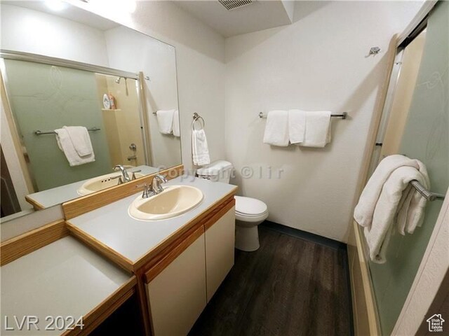 223 Hunter Ridge Rd Unit A202, Brian Head, UT 84719 - bathroom featuring toilet, an enclosed shower, vanity, and hardwood / wood-style floors