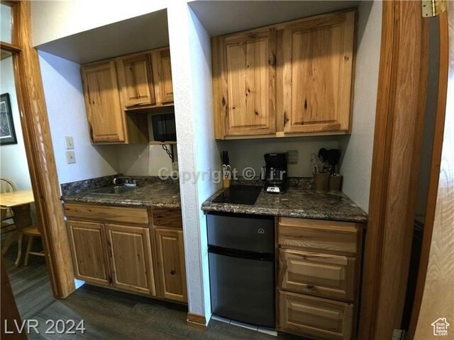 223 Hunter Ridge Rd Unit A202, Brian Head, UT 84719 - kitchen featuring dark stone countertops, dark hardwood / wood-style flooring, and sink