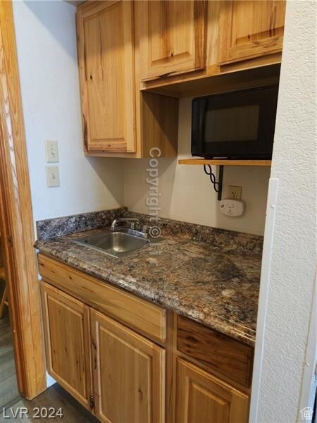 223 Hunter Ridge Rd Unit A202, Brian Head, UT 84719 - kitchen with dark stone counters, dark tile patterned flooring, and sink