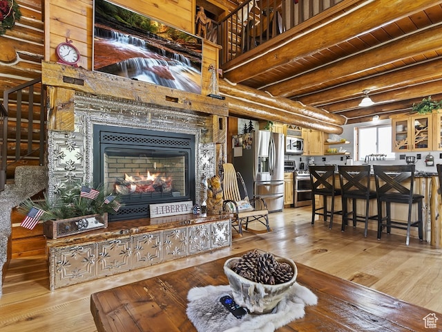 living room with beam ceiling and light hardwood / wood-style floors