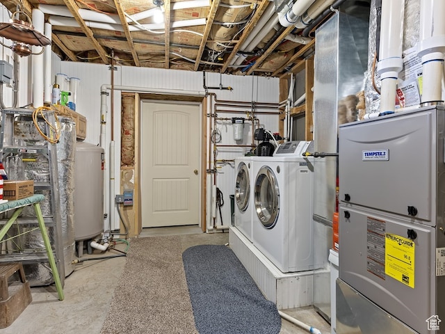 washroom featuring washing machine and dryer and water heater