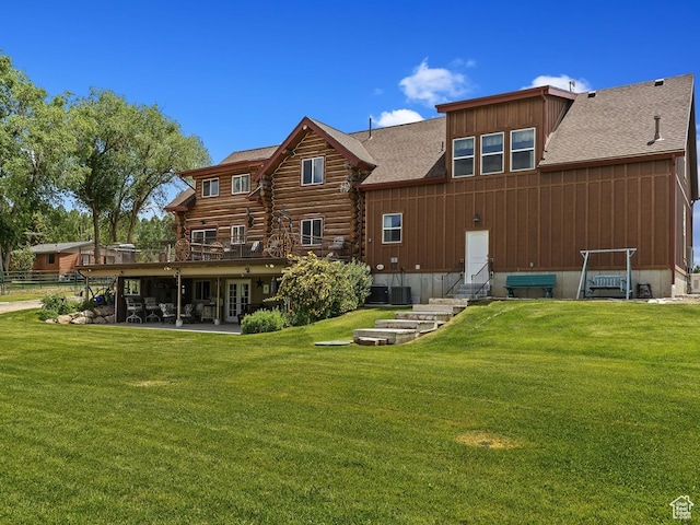 back of property featuring a patio and a yard
