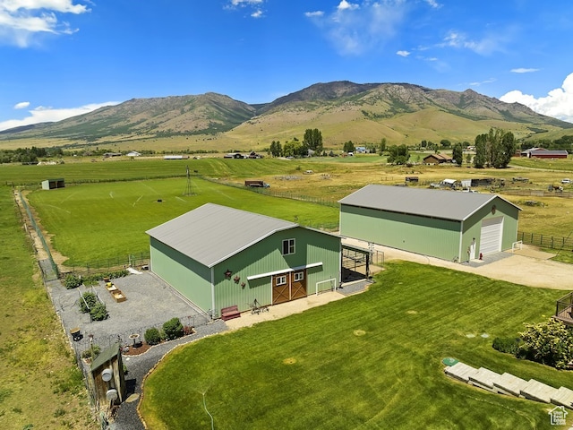 drone / aerial view with a mountain view and a rural view