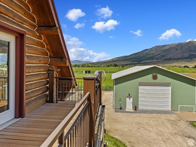 exterior space featuring a mountain view, an outdoor structure, and a garage