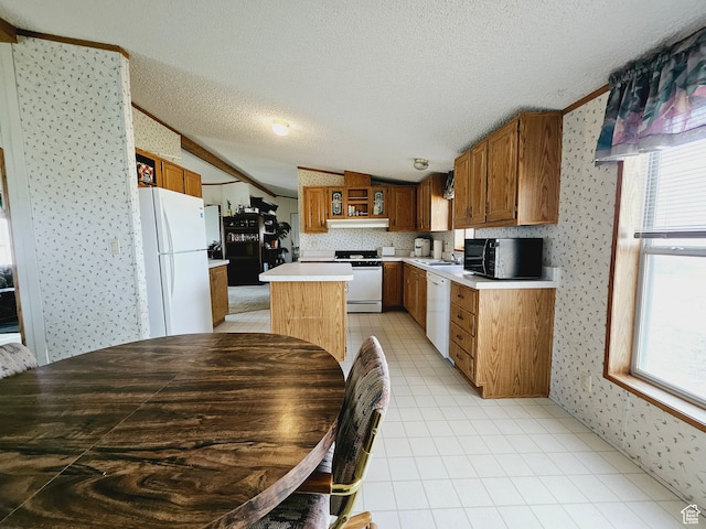 3628 E 3750 S, Ballard, UT 84066 - kitchen with a center island, sink, crown molding, a textured ceiling, and white appliances