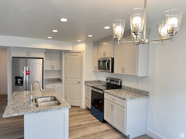 216 W Seasons Ln Unit 46, Garden City, UT 84028 - kitchen with appliances with stainless steel finishes, a sink, recessed lighting, an island with sink, and a chandelier