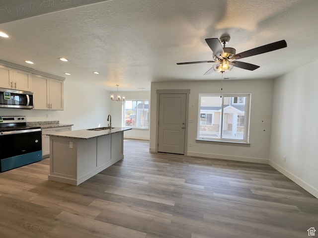 216 W Seasons Ln Unit 46, Garden City, UT 84028 - kitchen with stainless steel appliances, a sink, recessed lighting, a chandelier, and wood finished floors