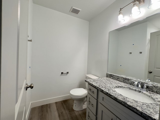 216 W Seasons Ln Unit 46, Garden City, UT 84028 - bathroom featuring wood finished floors, vanity, toilet, and baseboards