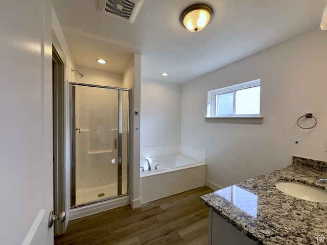 216 W Seasons Ln Unit 46, Garden City, UT 84028 - bathroom with a stall shower, wood finished floors, a bath, vanity, and baseboards