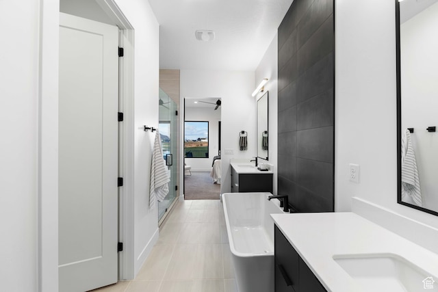 1560 W Torrey Pines Rd, Hurricane, UT 84737 - bathroom with tile walls, tile floors, vanity, and a bath to relax in
