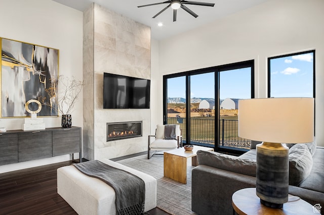 1560 W Torrey Pines Rd, Hurricane, UT 84737 - living room featuring ceiling fan, a tile fireplace, and dark hardwood / wood-style floors