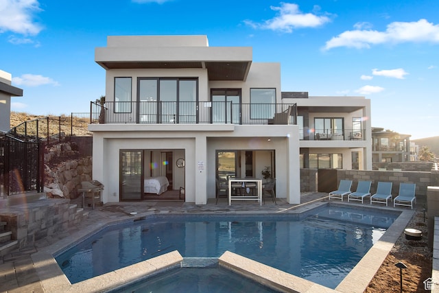 1560 W Torrey Pines Rd, Hurricane, UT 84737 - rear view of house featuring a pool with hot tub, a balcony, and a patio area