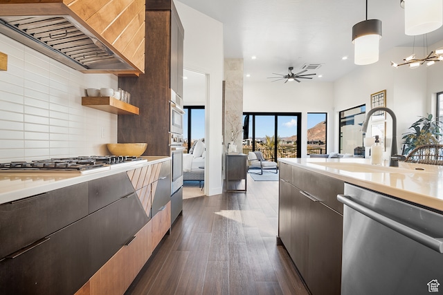1560 W Torrey Pines Rd, Hurricane, UT 84737 - kitchen with pendant lighting, custom exhaust hood, ceiling fan with notable chandelier, appliances with stainless steel finishes, and backsplash