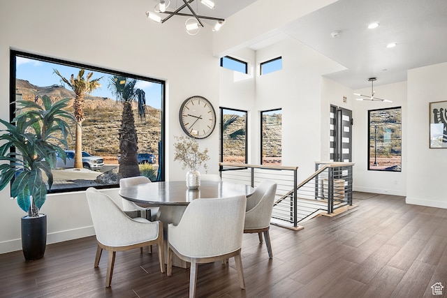 1560 W Torrey Pines Rd, Hurricane, UT 84737 - dining space with an inviting chandelier, dark wood-type flooring, and a towering ceiling