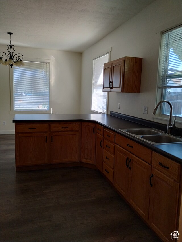 182 E 9000 S, Sandy, UT 84070 - kitchen featuring pendant lighting, a notable chandelier, kitchen peninsula, dark hardwood / wood-style flooring, and sink