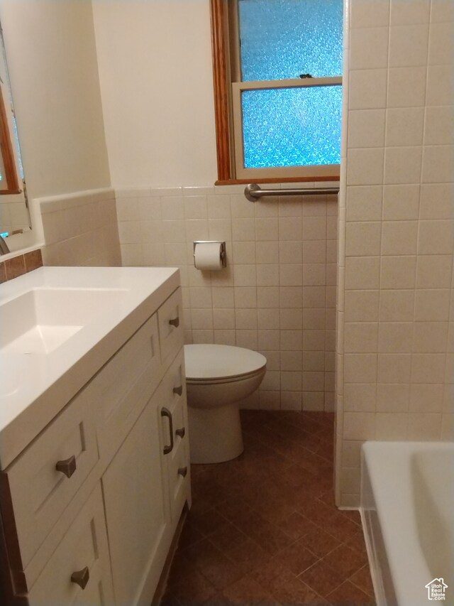 182 E 9000 S, Sandy, UT 84070 - bathroom with toilet, vanity with extensive cabinet space, tasteful backsplash, tile walls, and tile floors