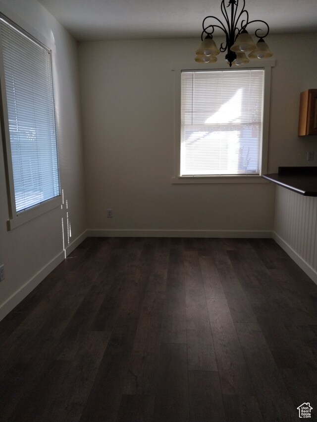 182 E 9000 S, Sandy, UT 84070 - unfurnished room featuring a notable chandelier and dark wood-type flooring
