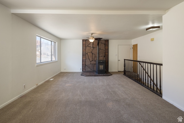 491 Mountain View Dr, Moab, UT 84532 - unfurnished living room with carpet flooring, a wood stove, and ceiling fan