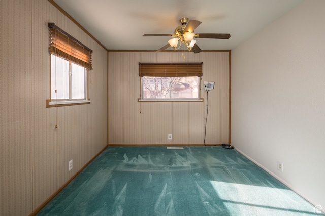 491 Mountain View Dr, Moab, UT 84532 - unfurnished room with ceiling fan, dark colored carpet, and ornamental molding