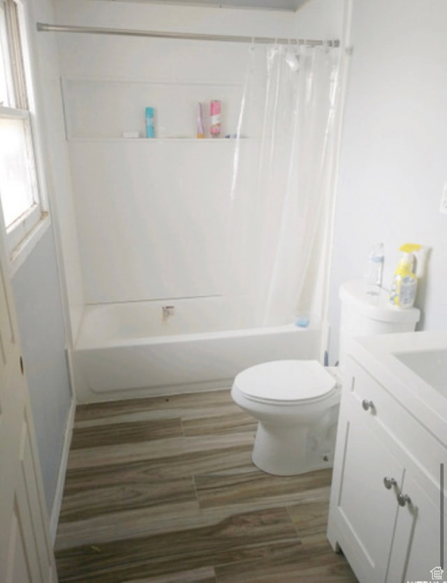 full bathroom with shower / bath combination with curtain, toilet, and vanity