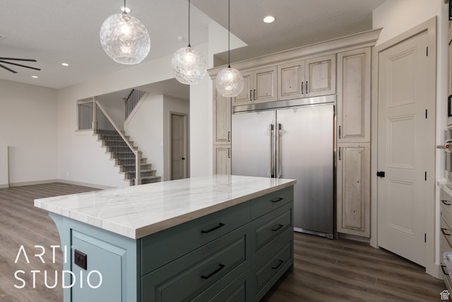 3209 S Dyami Vw Unit 11, Hurricane, UT 84737 - kitchen featuring decorative light fixtures, light stone counters, built in refrigerator, dark hardwood / wood-style floors, and a center island