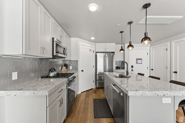 909 W Peace Tree Trl Unit 507, Heber City, UT 84032 - kitchen with sink, decorative light fixtures, a kitchen bar, high quality appliances, and hardwood / wood-style flooring