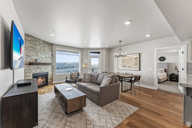 909 W Peace Tree Trl Unit 507, Heber City, UT 84032 - living room featuring an inviting chandelier, a stone fireplace, and light hardwood / wood-style floors
