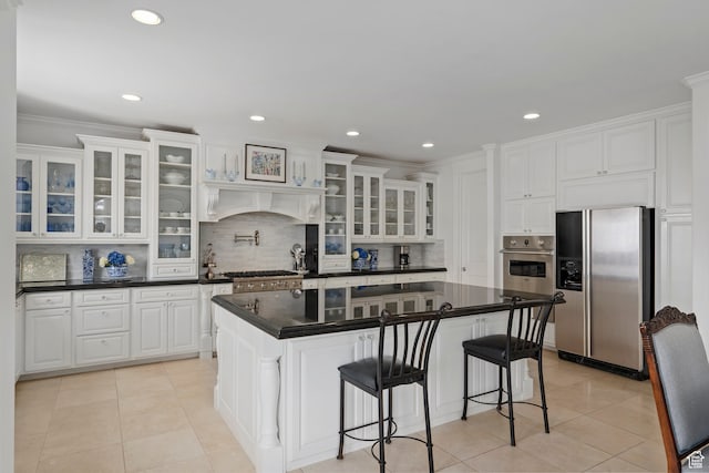 380 S Lindsay Spring Rd, Heber City, UT 84032 - kitchen with light tile patterned floors, appliances with stainless steel finishes, tasteful backsplash, white cabinets, and a kitchen island