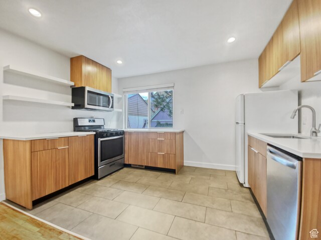 650 N 300 W Unit 218, Salt Lake City, UT 84103 - kitchen with stainless steel appliances, light tile flooring, and sink