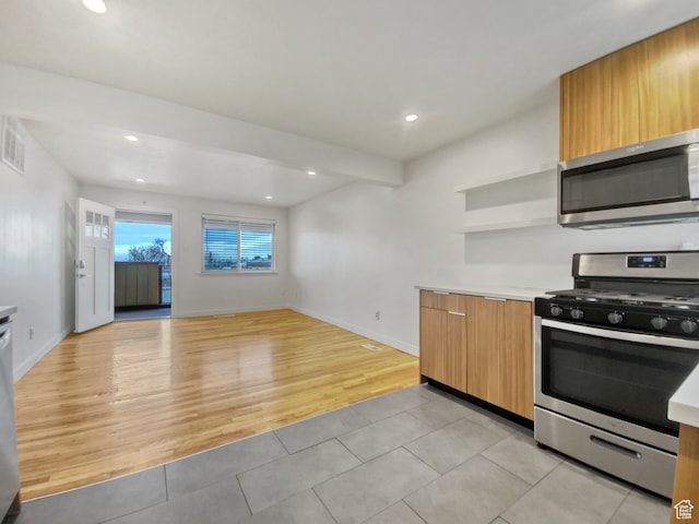 650 N 300 W Unit 218, Salt Lake City, UT 84103 - kitchen with light hardwood / wood-style floors, beamed ceiling, and stainless steel appliances