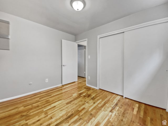 650 N 300 W Unit 218, Salt Lake City, UT 84103 - unfurnished bedroom with light hardwood / wood-style floors and a closet