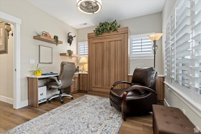 office area featuring plenty of natural light and dark wood-type flooring