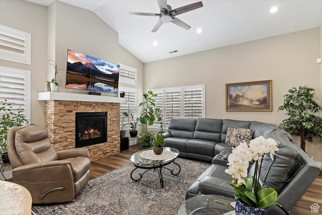 living room with ceiling fan, high vaulted ceiling, a fireplace, and dark hardwood / wood-style floors