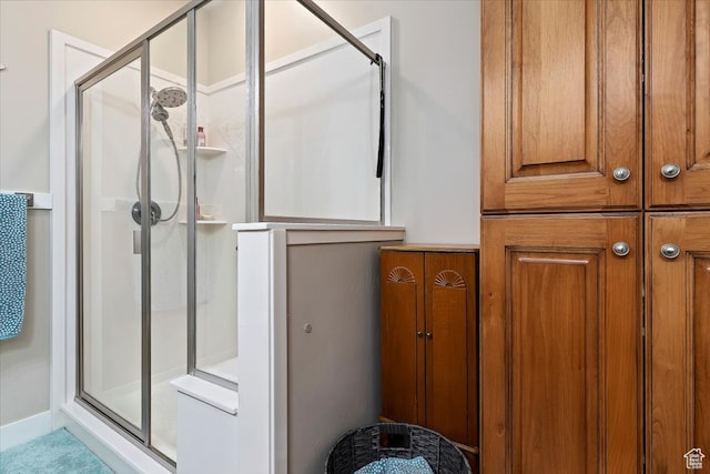 bathroom with a shower with door