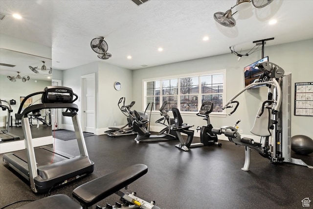 exercise room with a textured ceiling