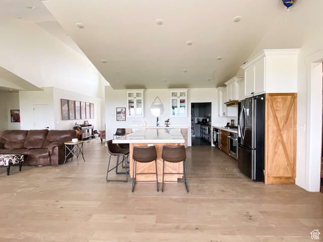 3213 N 4900 W, Malad City, ID 83252 - kitchen featuring oven, white cabinetry, light hardwood / wood-style floors, a center island, and fridge