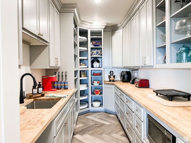 3213 N 4900 W, Malad City, ID 83252 - kitchen featuring gray cabinetry, light parquet floors, wood counters, and sink